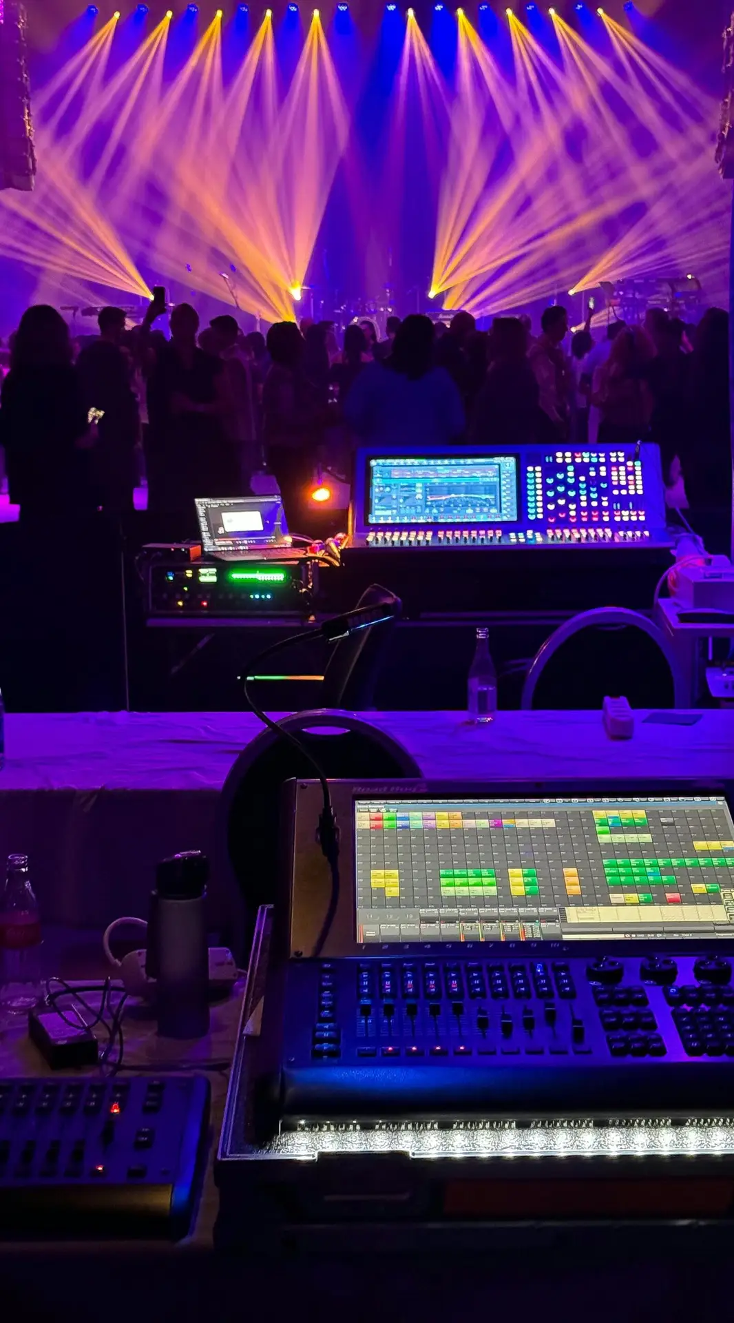 Dynamic concert scene with colorful stage lights and sound equipment.